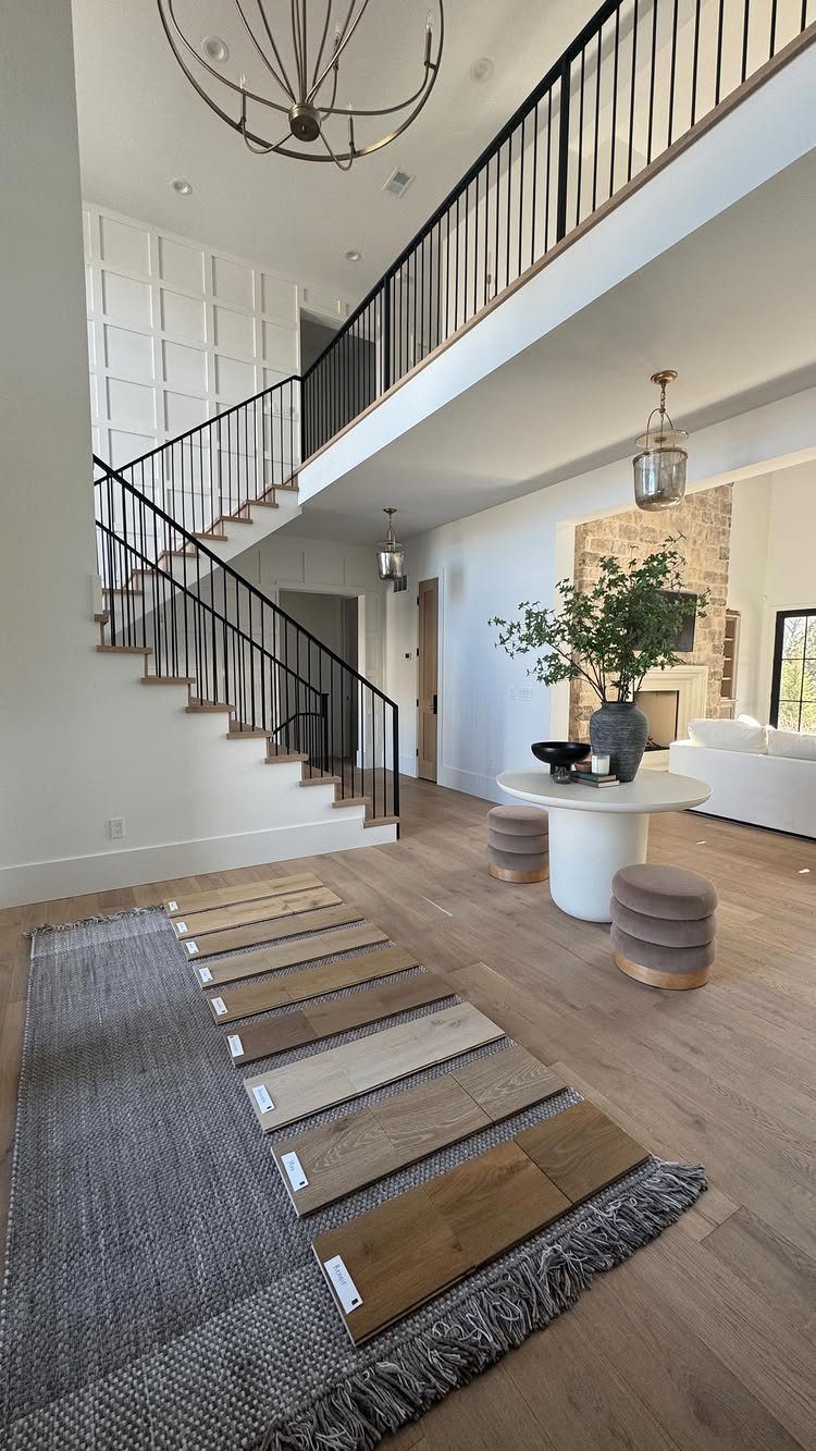 Cool Tone Wood Floors: 6 Mix-and-Match Ideas for Modern Matches 5 Wood floor samples laid on a grey rug over light wood flooring in a modern room.