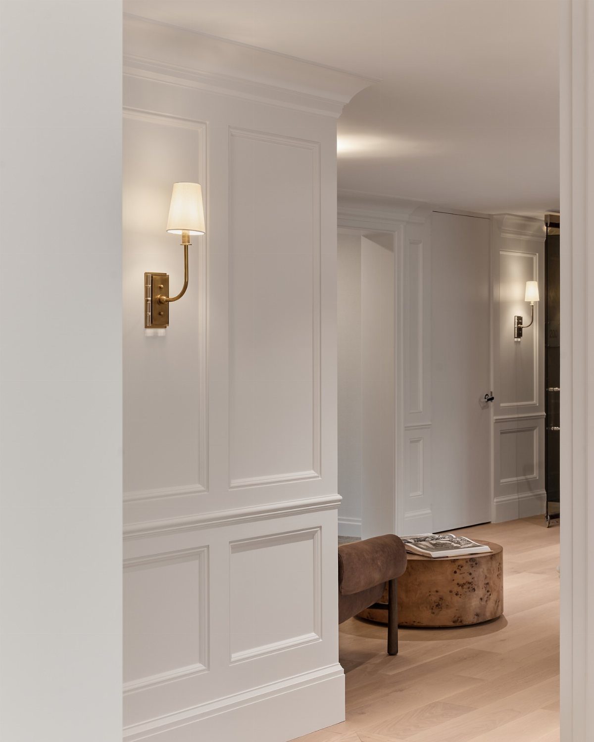 Decorative Wall Molding: 7 Panel Styles for Every Room 3 White wainscoting panels with decorative molding on a wall in a bright room.