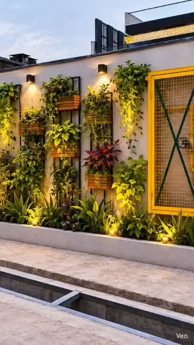 15 Feature Wall Ideas That Rely on Material, Not Just Color 13 Lush green plants growing in wooden wall planters on a white exterior wall.
