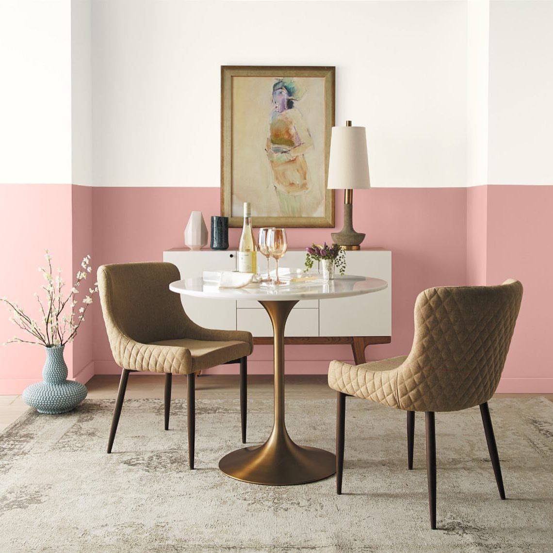 15 Feature Wall Ideas That Rely on Material, Not Just Color 12 Dining room with a two-tone wall featuring white and pink paint, a marble table, and tan chairs.