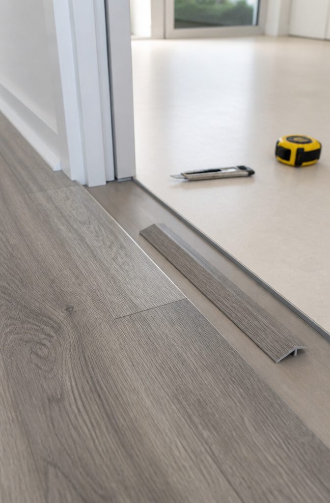 How to Install LVP Flooring: 11 Steps from Acclimation to Final Touches 9 Transition strip and gap between two flooring types.