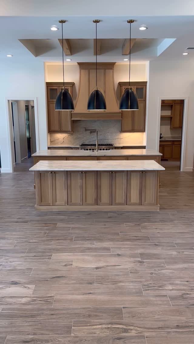 Kitchen Floor Colors: 14 Ideas for 2026 3 Wood-look porcelain floor tiles in a large, modern kitchen with light wood cabinetry.