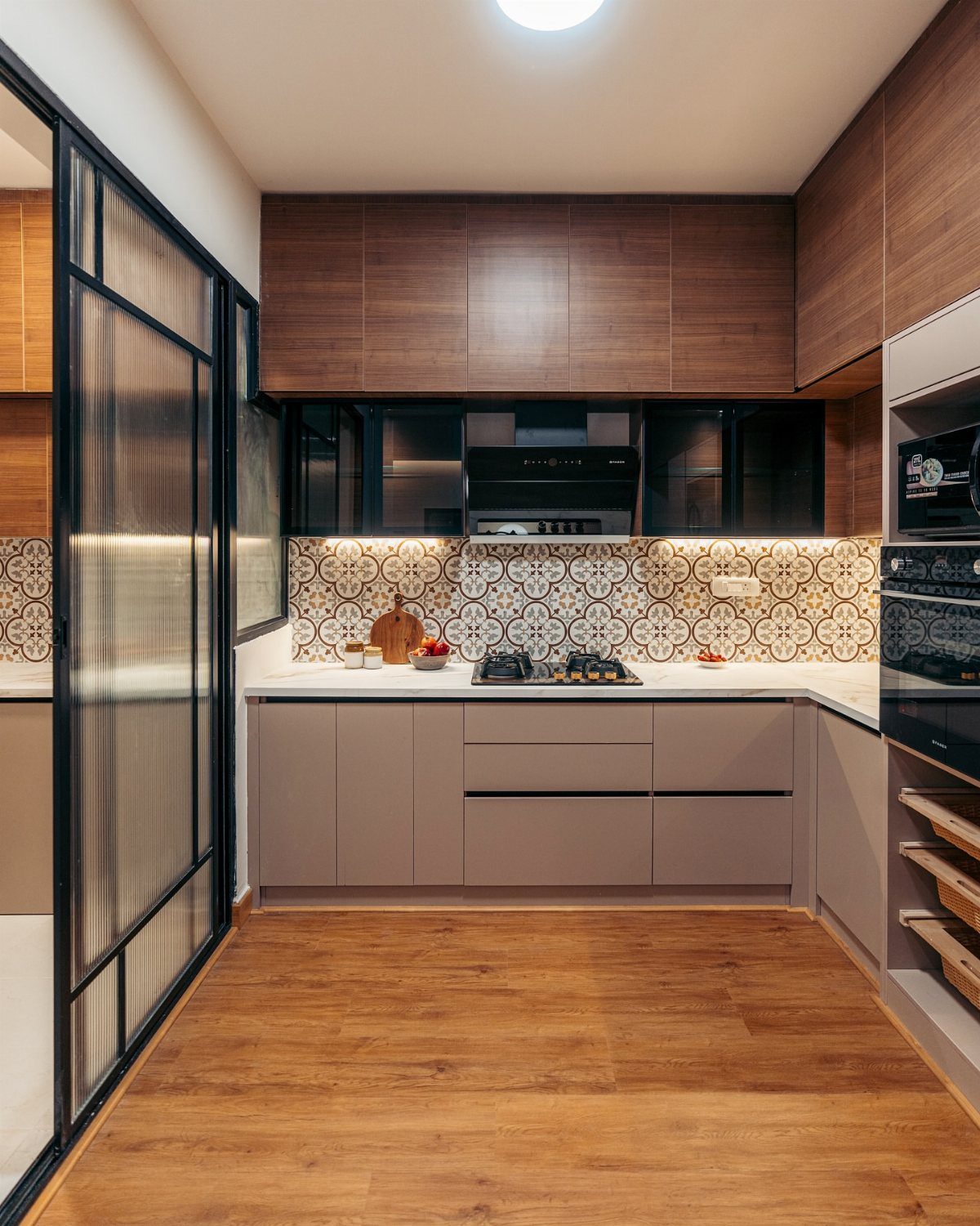 Kitchen Floor Colors: 14 Ideas for 2026 2 Modern kitchen with light brown wood-look flooring, beige cabinets, and a decorative patterned backsplash.
