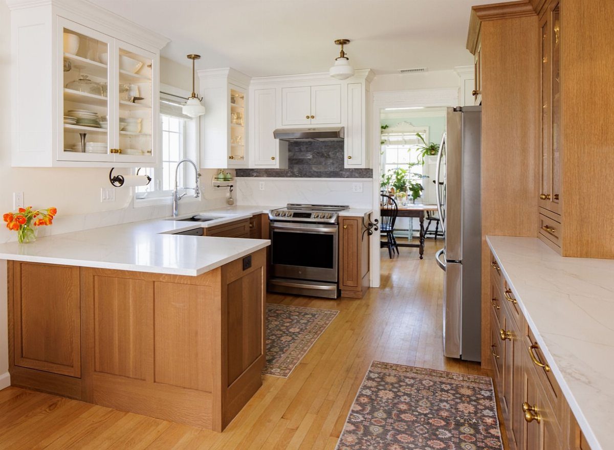 9 Kitchen Hardwood Flooring Ideas for Light to Bold Contrast 1 Light wood kitchen flooring in a bright room with white and wood cabinets.