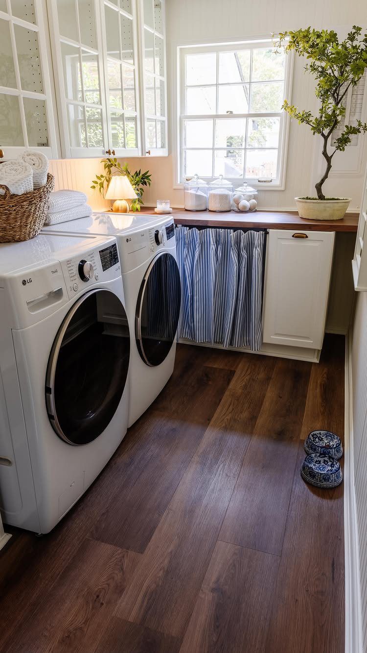 Dark wood-look plank flooring in a bright laundry room with white appliances.