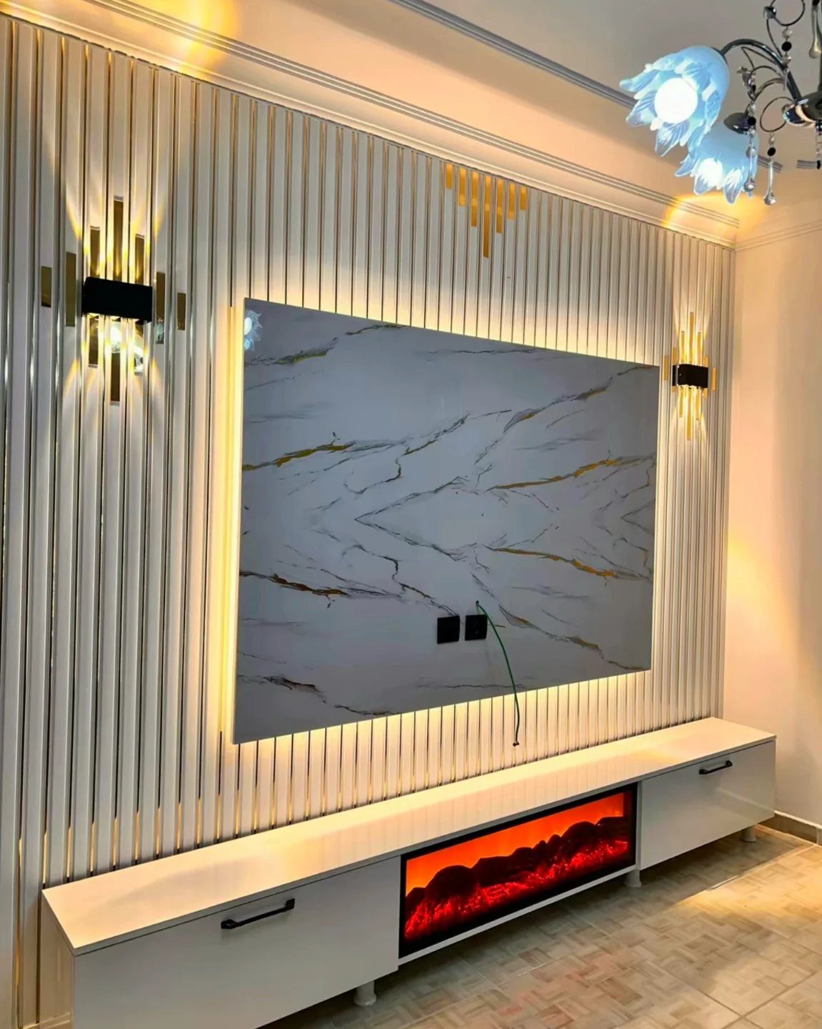 White fluted wall panels with marble effect center piece and warm integrated LED lighting.