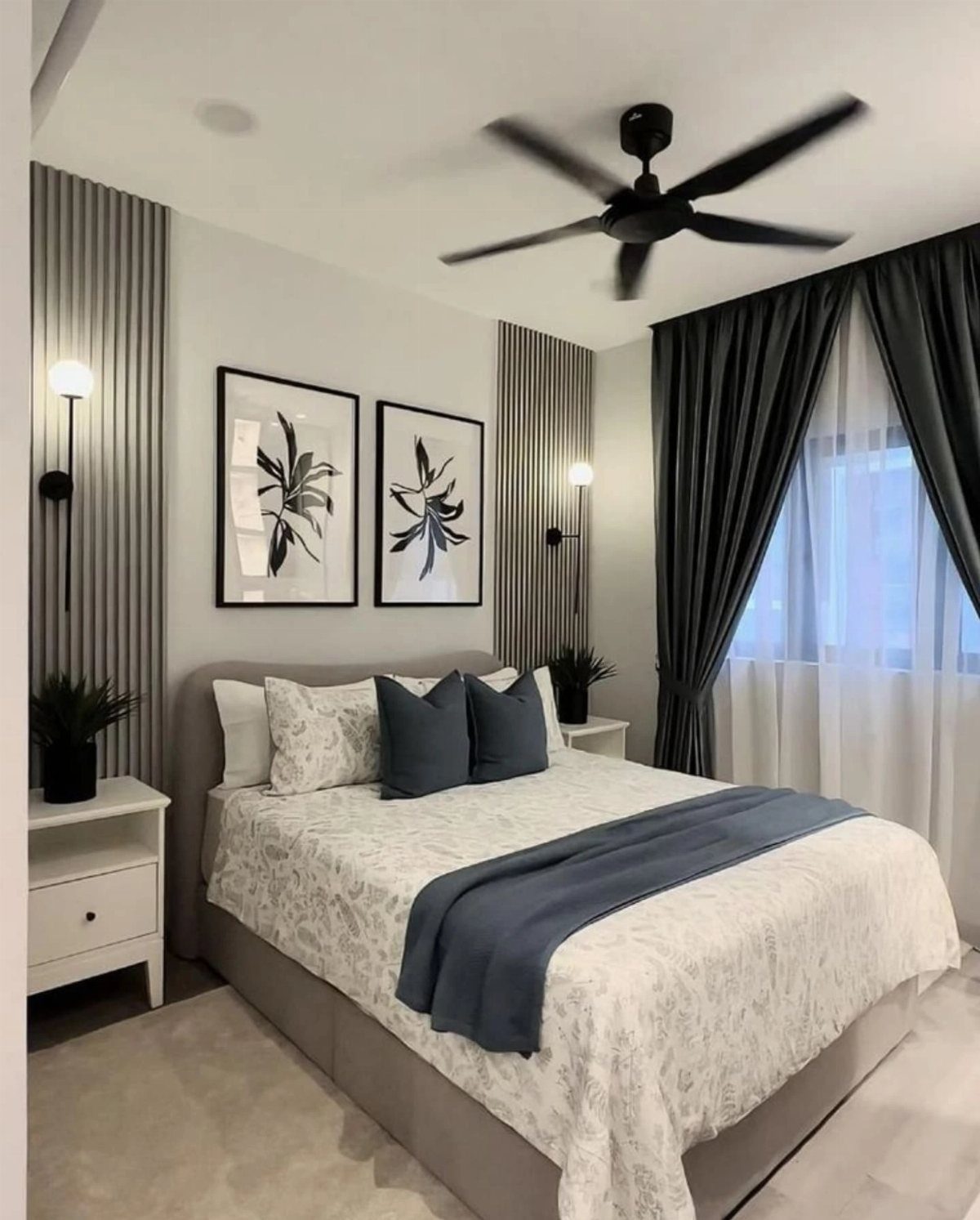 Modern bedroom with a bed, botanical art, and vertical striped wall panels.
