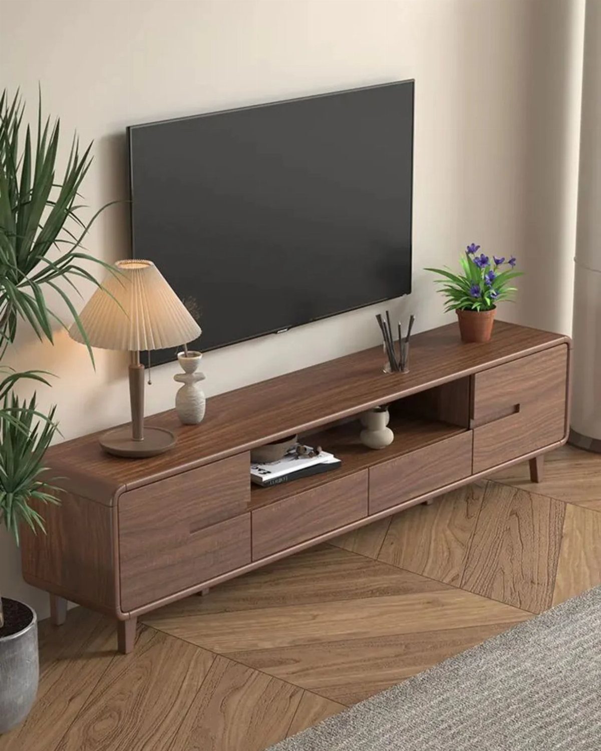 A dark wood media console with drawers and open shelving under a wall-mounted television.