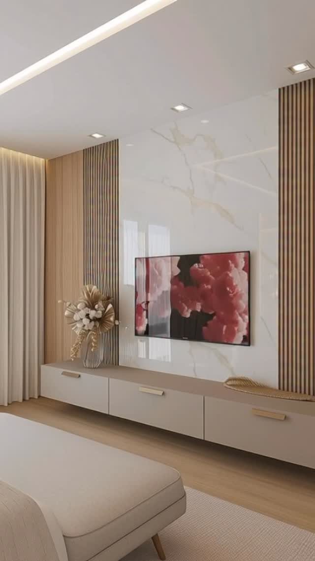 Television mounted on a white marble wall flanked by vertical light wood slats and a beige console.