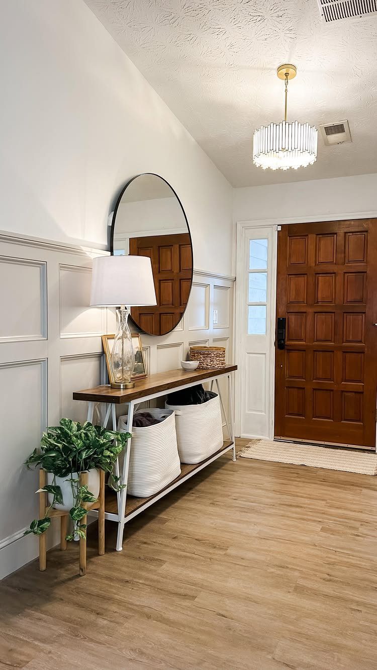 8 Wall Molding Design Ideas for Rooms That Need More Structure 1 Grey board and batten wall molding in a bright hallway with a wooden console table.