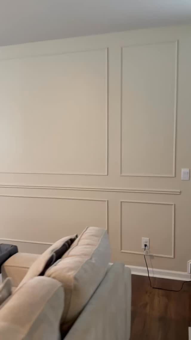 8 Wall Molding Design Ideas for Rooms That Need More Structure 5 Cream walls decorated with large rectangular picture frame moulding sections above a chair rail.