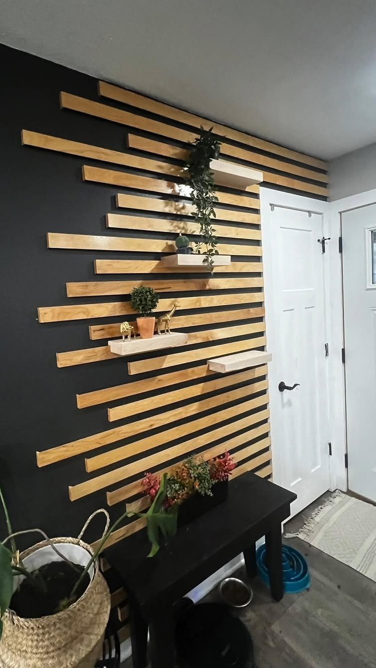 Light wood slats arranged in a staggered pattern on a dark accent wall with small shelves.