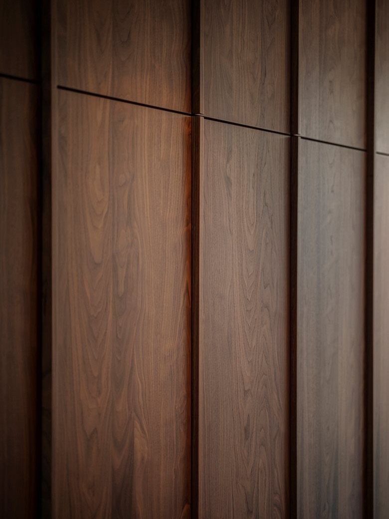 Dark brown vertical wood panels with a natural grain texture and recessed lines.
