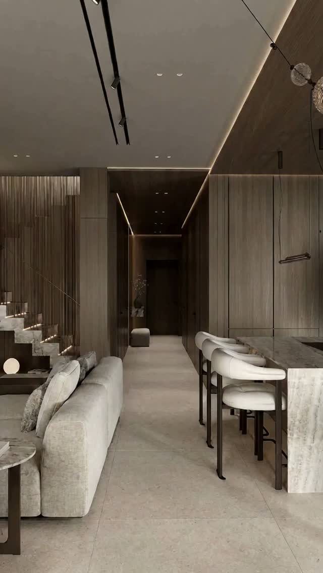 Minimalist wood paneling covers the walls and kitchen cabinetry in a modern, neutral-toned living space.
